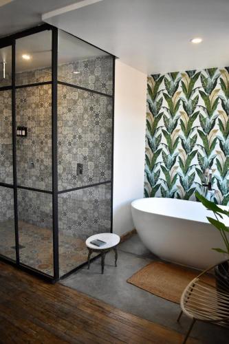 a bathroom with a large tub and a shower at Casa Pepe in Mexico City