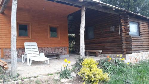 a wooden cabin with a chair in front of it at Piramida Mjeseca in Visoko