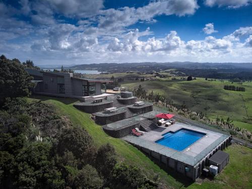 an aerial view of a house on a hill with a swimming pool at Parua Bay home with everything you'll need in Parua Bay