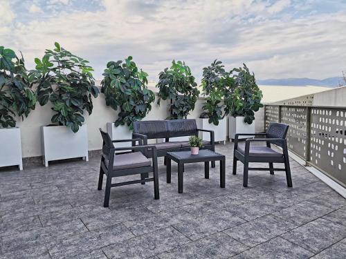 a group of chairs and a table on a patio at Guest rooms Denicija in Skopje