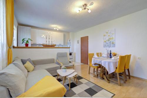 a living room with a couch and a dining room at Josipa & Jelena Apartment in Senj