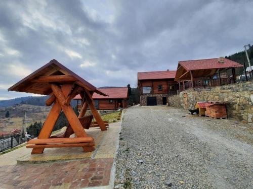 a wooden structure sitting on the side of a house at Карпатский Рай in Yaremche
