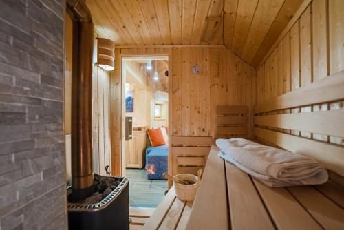 a small room with a bed in a wooden cabin at Alpine Chalet Velika Planina - Irenca - I Feel Alps in Stahovica