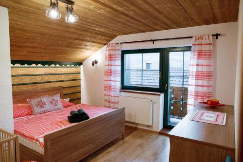 a bedroom with a bed and a large window at Apartmán Elenka in Zuberec