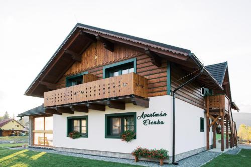a house with a balcony on top of it at Apartmán Elenka in Zuberec