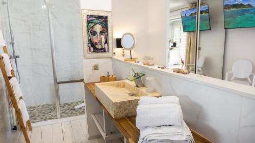 a bathroom with a sink and a shower at Residence Bleu Marine - Sea View Apartments & Studios - Saint-Martin French Side in Grand Case