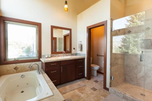 a bathroom with a tub and a shower and a sink at Downwider at The Columbia River Gorge in Hood River
