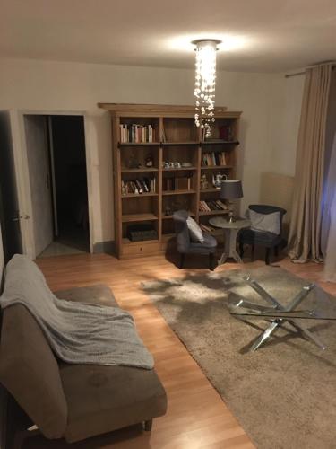sala de estar con sofá, sillas y lámpara de araña en Spacieux, en Belfort
