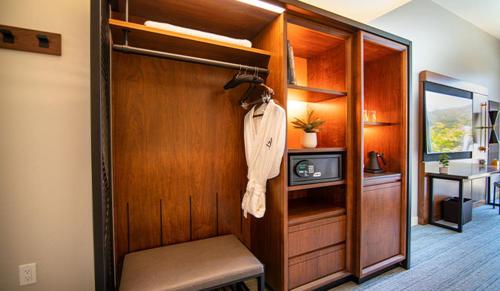 a room with a closet with a sink and a desk at The Ameswell Hotel in Mountain View