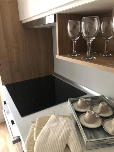 a kitchen with wine glasses and a tray of dishes at B&B Degli Artisti in Lecce