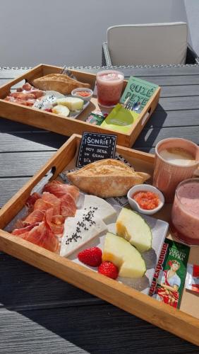 two trays of different types of food on a table at Caléndula Beach 1ºLinea mar in Caleta de Sebo