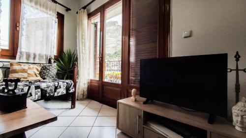 a living room with a large flat screen tv at The balcony of Meteora the center of kalabaka in Kalabaka