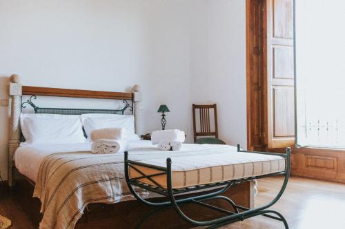 a bedroom with a large bed with white pillows at Casa dos Vales - Luxury Villa in Penafiel