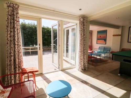 a living room with sliding glass doors and a pool table at Arlington House in Matlock