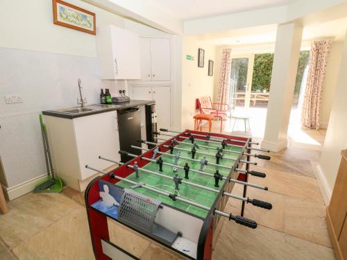 a kitchen with a foosball table in the middle of a room at Arlington House in Matlock