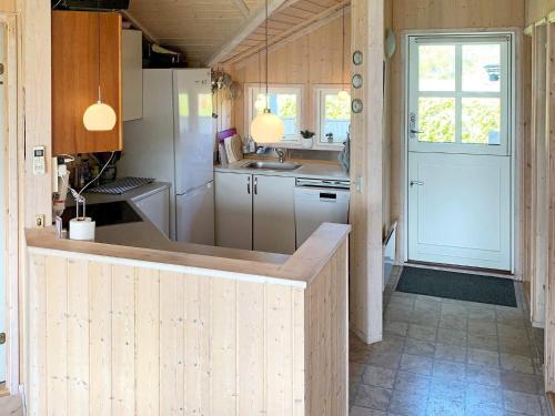 a kitchen with a counter and a white refrigerator at Holiday home Nakskov VI in Nakskov