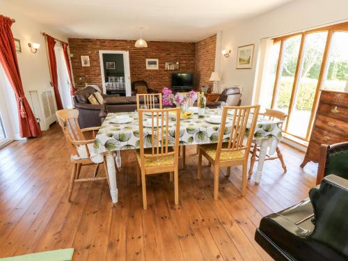 a dining room with a table and chairs at The Coach House in Ryde