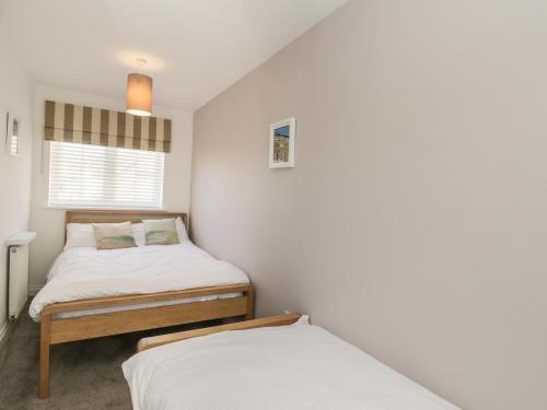 a bedroom with two beds and a window at Seadrift in Filey