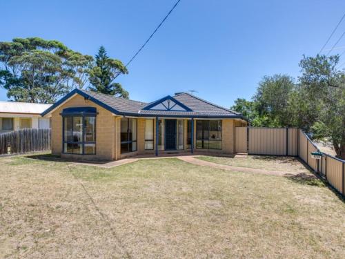 a house with a fence in front of it at Stones Throw To The Beach in Tootgarook