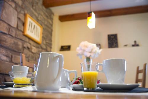 a table with cups and glasses of orange juice at Argonz Etxea in Urzainqui
