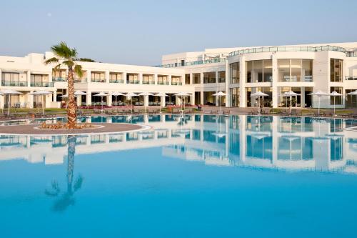 a large swimming pool in front of a building at Apollo Blue in Faliraki