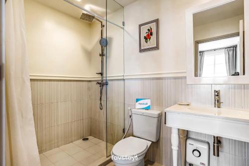 a bathroom with a toilet and a sink and a shower at Summer Hua Hin by Favstay in Hua Hin
