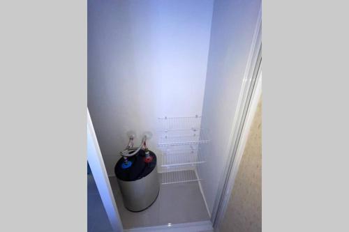 a hallway with a trash can with an umbrella at Penthouse with private rooftop near the airport. in La Javilla