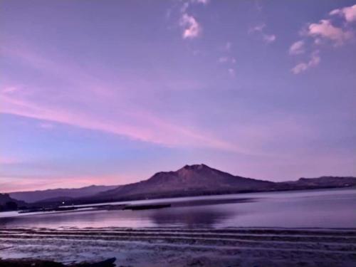 a view of a body of water with a mountain at Batur Green Lakeview in Kintamani Bali in Kintamani