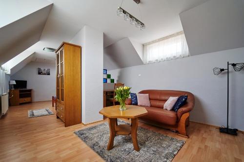 a living room with a couch and a table at Hotelik Gołdap in Gołdap