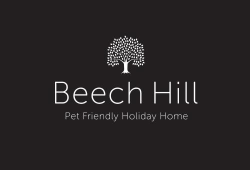 a logo for a holiday home with a tree at Beech Hill - Pet Friendly Holiday Home in Tasman