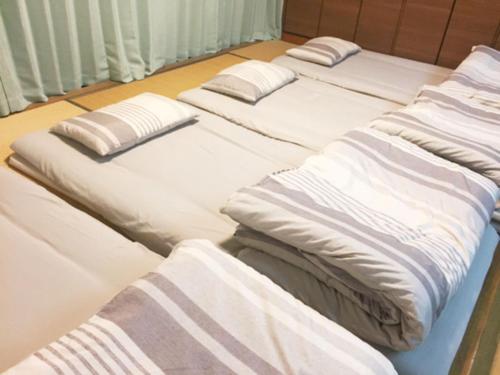 Giường trong phòng chung tại Rental Villa Luana Waioli