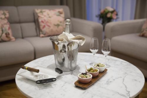a table with a bucket and wine glasses on it at Warwick Reine Astrid - Lyon in Lyon