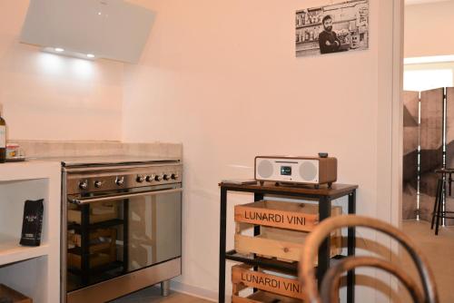 a kitchen with a stove top oven next to a counter at The Old Bakery in Cagliari