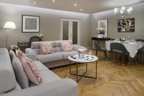 a living room with a couch and a table at Warwick Reine Astrid - Lyon in Lyon