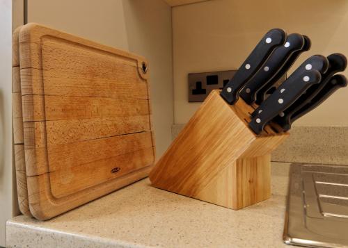 a block of knives sitting on a counter next to a knife block at Escape Ordinary at Castle Hume in Enniskillen