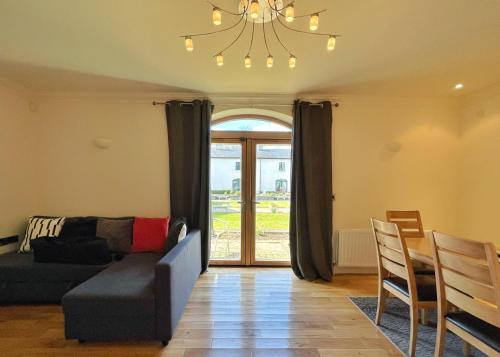 a living room with a couch and a table at Escape Ordinary at Castle Hume in Enniskillen