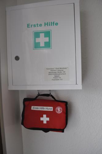 a sign is hanging on a wall next to a box at Ferienhaus Groß Moorburg in Südbrookmerland