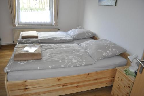 a bed with two pillows on it in a bedroom at Ferienhaus Groß Moorburg in Südbrookmerland
