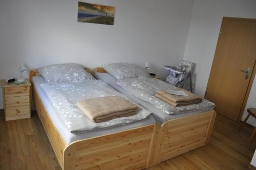 a bed in a room with two pillows on it at Ferienhaus Groß Moorburg in Südbrookmerland