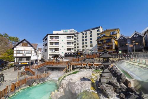 a water park at a resort with a waterfall at Daitokan in Kusatsu