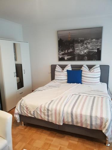 a bedroom with a bed with a picture on the wall at Ferienwohnung Finkenweg in Bad Neuenahr-Ahrweiler