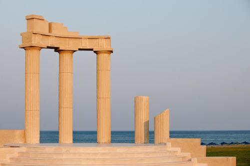 an image of a monument with columns and the ocean at Apollo Blue in Faliraki