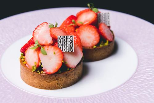two mini cakes with strawberries on a white plate at Fauchon Hotel Kyoto in Kyoto