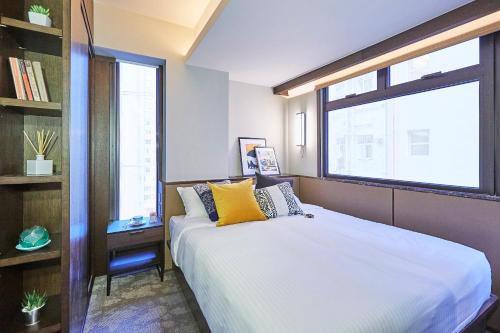 a bedroom with a large bed and a window at Princeton Residence in Hong Kong