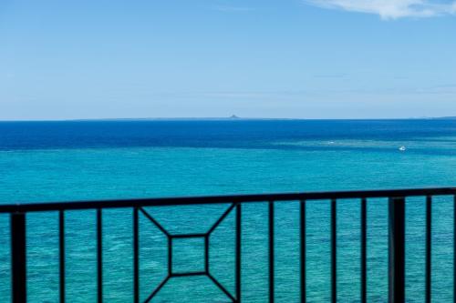 a view of the ocean from a balcony at Hotel Monterey Okinawa Spa & Resort in Onna