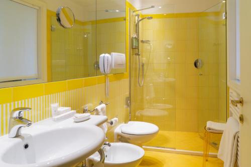 a bathroom with a sink and a shower and a toilet at Villa Abbondanzi Resort in Faenza