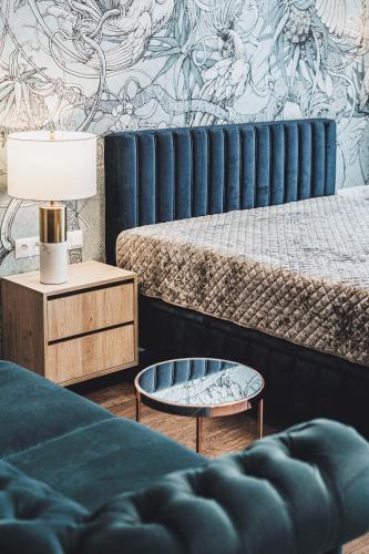 a bedroom with two beds and a coffee table at Apartament SPA Lublin Centrum in Lublin