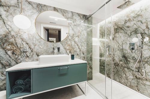 a bathroom with a sink and a mirror at Apartament SPA Lublin Centrum in Lublin