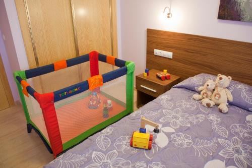 a childs bedroom with a bed with toys on it at Apartamentos Campuebla in Montanejos