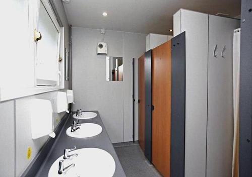 a public bathroom with two sinks and two stalls at Inveraray Hostel in Inveraray